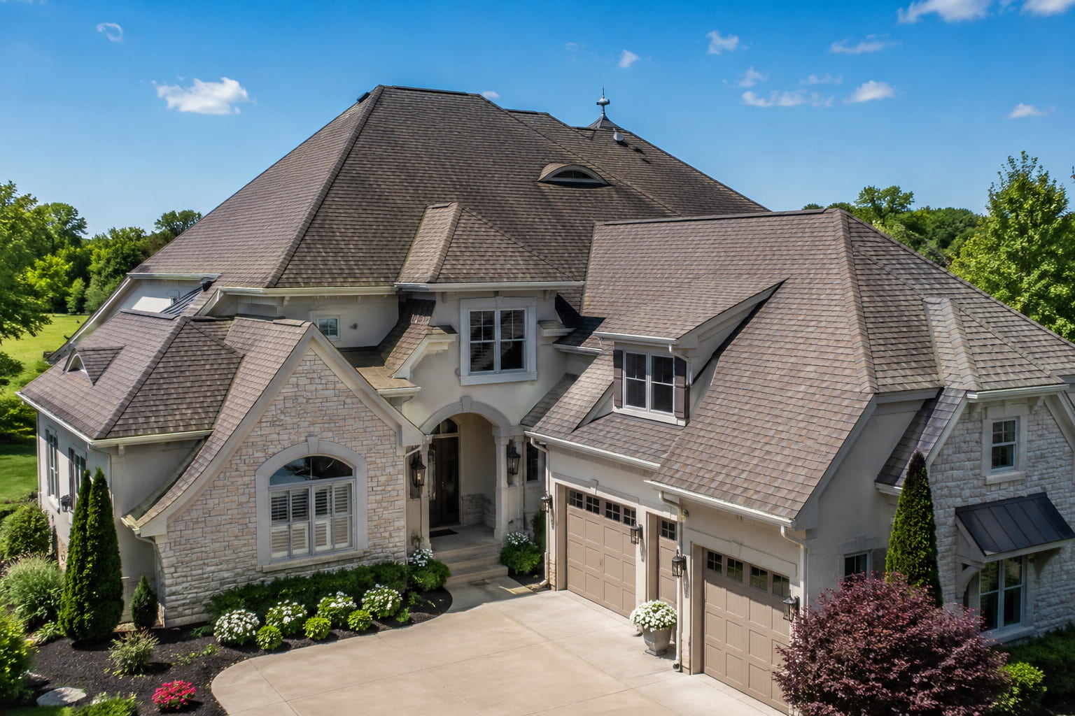 Complex residential roof with multiple gables, valleys, and roof planes showing how roof shape affects total roof area calculation.